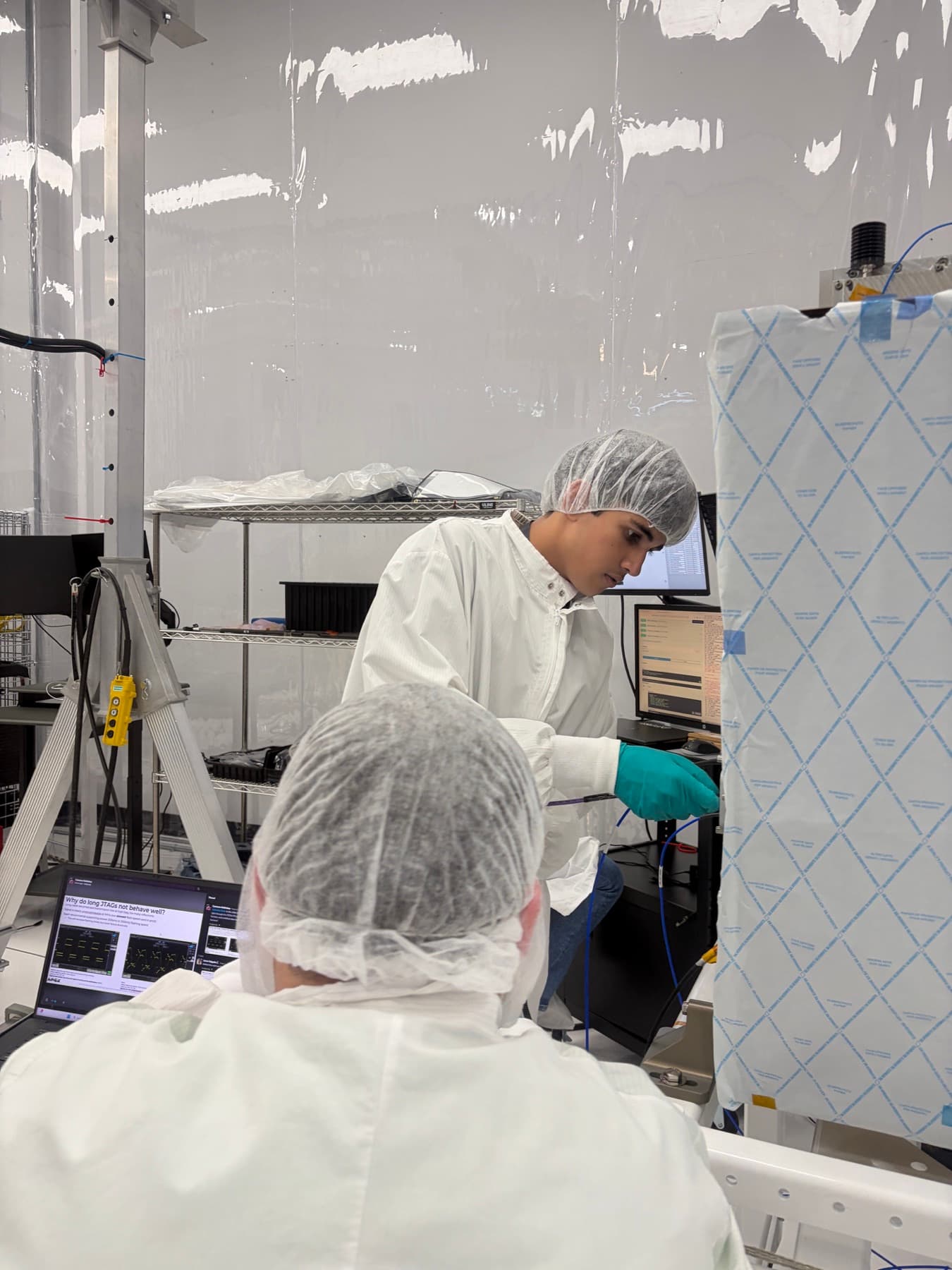 Arav working with spacecraft hardware in an Apex cleanroom